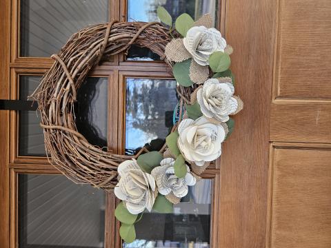 wreath on door with flowers made out of old recycled book pages
