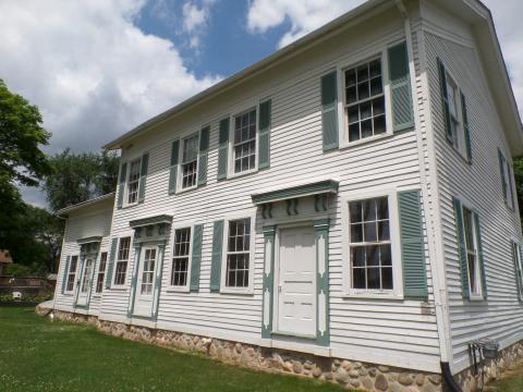 Photo of a white, historic colonial-style house. Provided by the Troy Historic Village. 