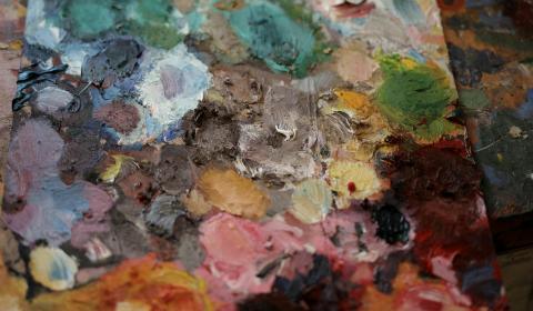 A painter's pallet with a variety of colors of paint. Photographed by Andrea Piacquadio.