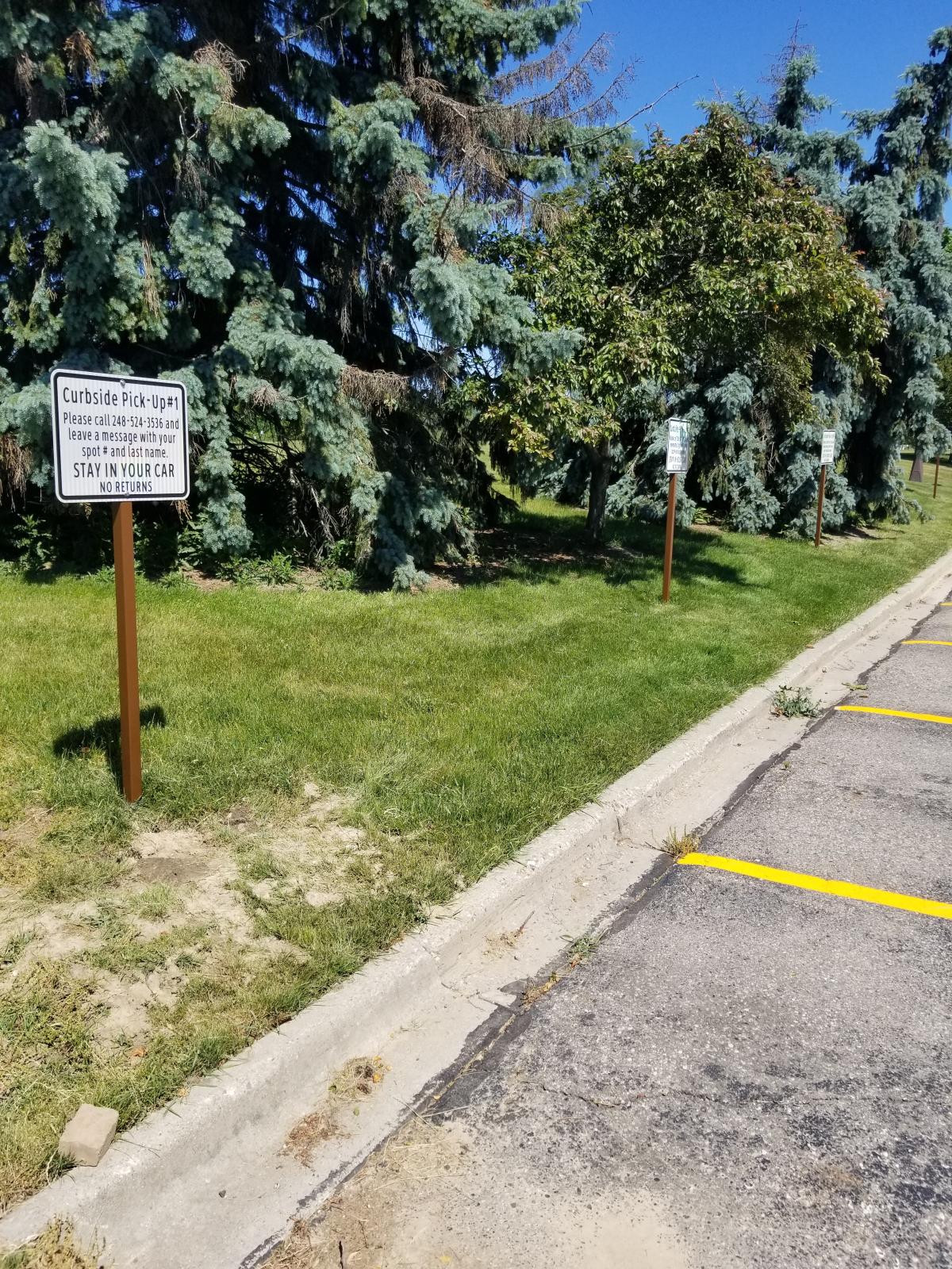 Curbside Pickup signs in parking lot. 